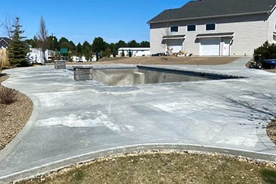 Concrete swimming pool deck design and installation by Palominos Landscaping of Caldwell Idaho